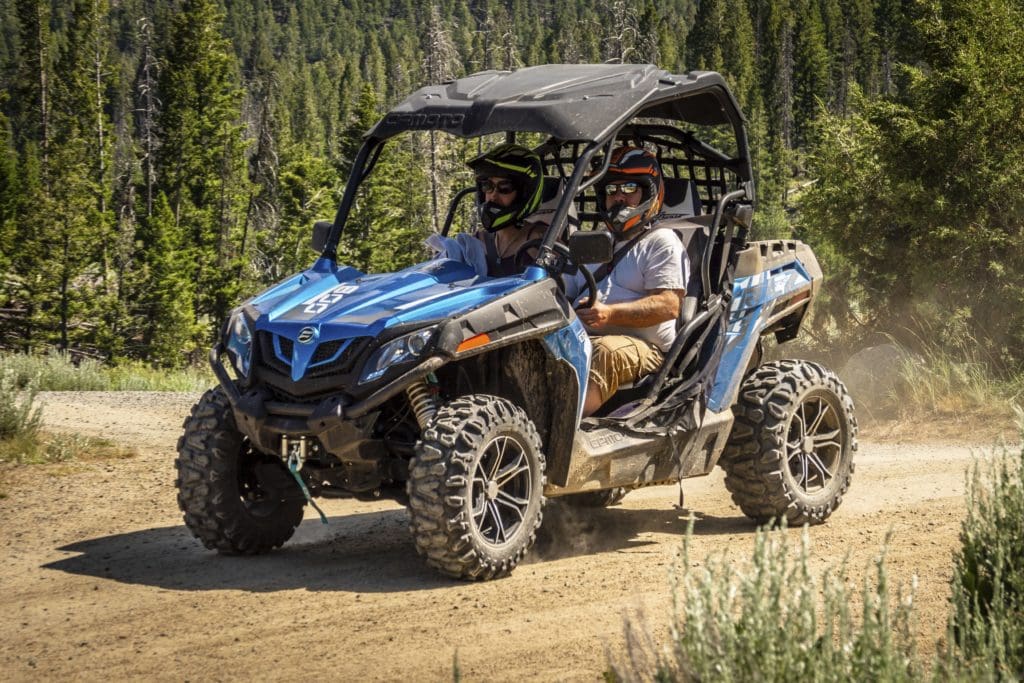 a family rides in ATV/UTV Off Road vehicle in the Black Hills